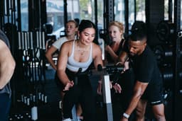 Coach training member during a functional conditioning session on the turf at The Yard Gym USA, premium strength and conditioning gym.